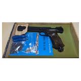 Smith & Wesson Model 78G CO2 pellet pistol with wood target-style grip, black finish and adjustable rear sight. Includes Smith & Wesson Model 78G & 79G literature and pellets as shown.