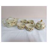 Six-piece Hall Autumn Leaf group including two lidded teapots and four matching cups with gold trim. Square teapot is marked “Made Especially for The Autumn Leaf Club by The Hall China Co. 2000”; 