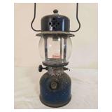 Vintage Coleman Model 243A Pressure Lantern. Single-mantle lantern with dark blue painted fount, black ventilator, clear Coleman replacement globe and wire bail handle; collar marked Model 243A and sh