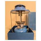 Sears Model 72217 Lantern with Metal Carrying Case. Blue pressure lantern with matching blue porcelain ventilator, clear globe and wire bail handle, housed in a blue metal carrying case; shows general