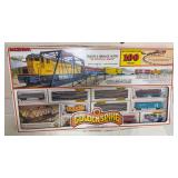 Bachmann Golden Spike HO scale electric train set in original box, advertised as containing over 100 pieces. Includes locomotive, cars, track, power pack and trestle bridge with blinking light as show