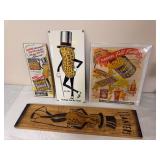 Planters Mr. Peanut advertising grouping including metal sign, framed/printed advertising pieces and wood plaque as shown. Mixed ages, materials and condition.