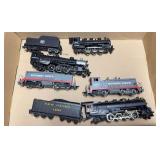 Group of HO scale locomotives and tenders including Southern Pacific diesel units, New Haven steam locomotive and tender, and additional steam locomotive as shown. Mixed makers and condition.