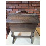 Vintage Wooden Magazine Stand. Dark-finished wood floor stand with handled hinged top/storage compartment and lower open rack; catalog measurements are 24" high x 18" wide x 11" deep.
