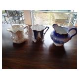 3 antique pitchers as shown