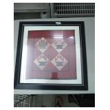 Red quilt picture in black frame. Approx 21×21