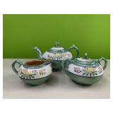 Porcelain tea pot, creamer, and sugar