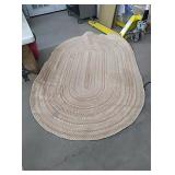 Tan and burgundy oval rug. Approx8ft×5ft