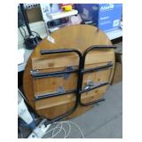 Round wood table with folding metal legs. Approx