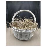 White basket with white decorative twigs approx