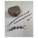 Trinket box with pins and parts of a rosary