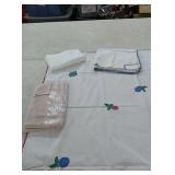 6 tablecloths and 3 potholders some with stains