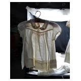 Vintage baby dresses on vintage hangers