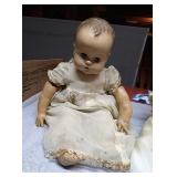 2 vintage baby dolls in vintage baby clothes. One