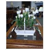 White wooden basket with white artificial tulips.