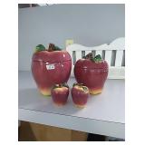 2 apple canisters with salt and pepper shakers to