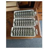 3 metal ice cube trays in holder