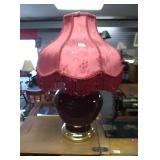 Large burgundy decorative lamp with fringed shade