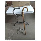 2 canes one metal adjustable and one carved wood