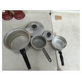 3 various size pans, 2 with lids, 1 has handle