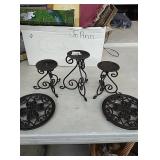 3 decorative candle holders and 2 metal trivets