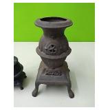 Pair of cast iron stove figurines....larger one