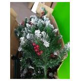 Snow flocked Christmas tree with berry