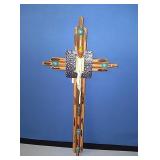 New wood and metal cross with melting candle and