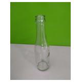 24 small glass 6.3 oz glass bottles. 7.5" tall ×