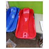 Pair of red and blue sleds