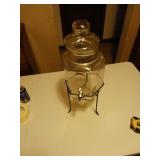 Glass beverage dispenser on iron stand