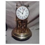 Mechanical brass clock. Good shape. Glass dome