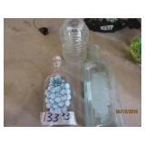 3 Bottles, two of them have grapes on them