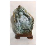 Jade carving on wood platform
