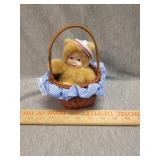 Little bear in a basket porcelain doll by Anne
