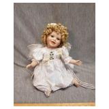 Smiling porcelain doll with curly hair