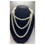 Extra long strand of white glass pearls from
