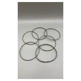 6 silver bangle bracelets.