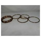 5 Bracelets. Beautiful gold tone bracelets with