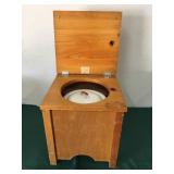 Vintage child’s commode with porcelain pot and