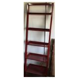 Leaning wall shelf red in color