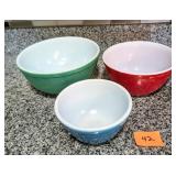 Three Pyrex Mixing Bowls. There are scratches and