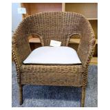 Wicker chair with cushion. Some peeling. Good cond