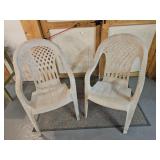 Two modern outdoor plastic resin chairs.