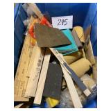 Tub of sandpaper and stir sticks