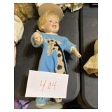 Ceramic doll in pajamas with stand