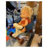 Doll in wooden cart