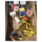 Assorted sewing items, thread, and needles