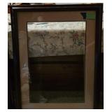 A dark wood frame with a brown matte