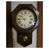 A vintage wooden Bulova hanging clock.